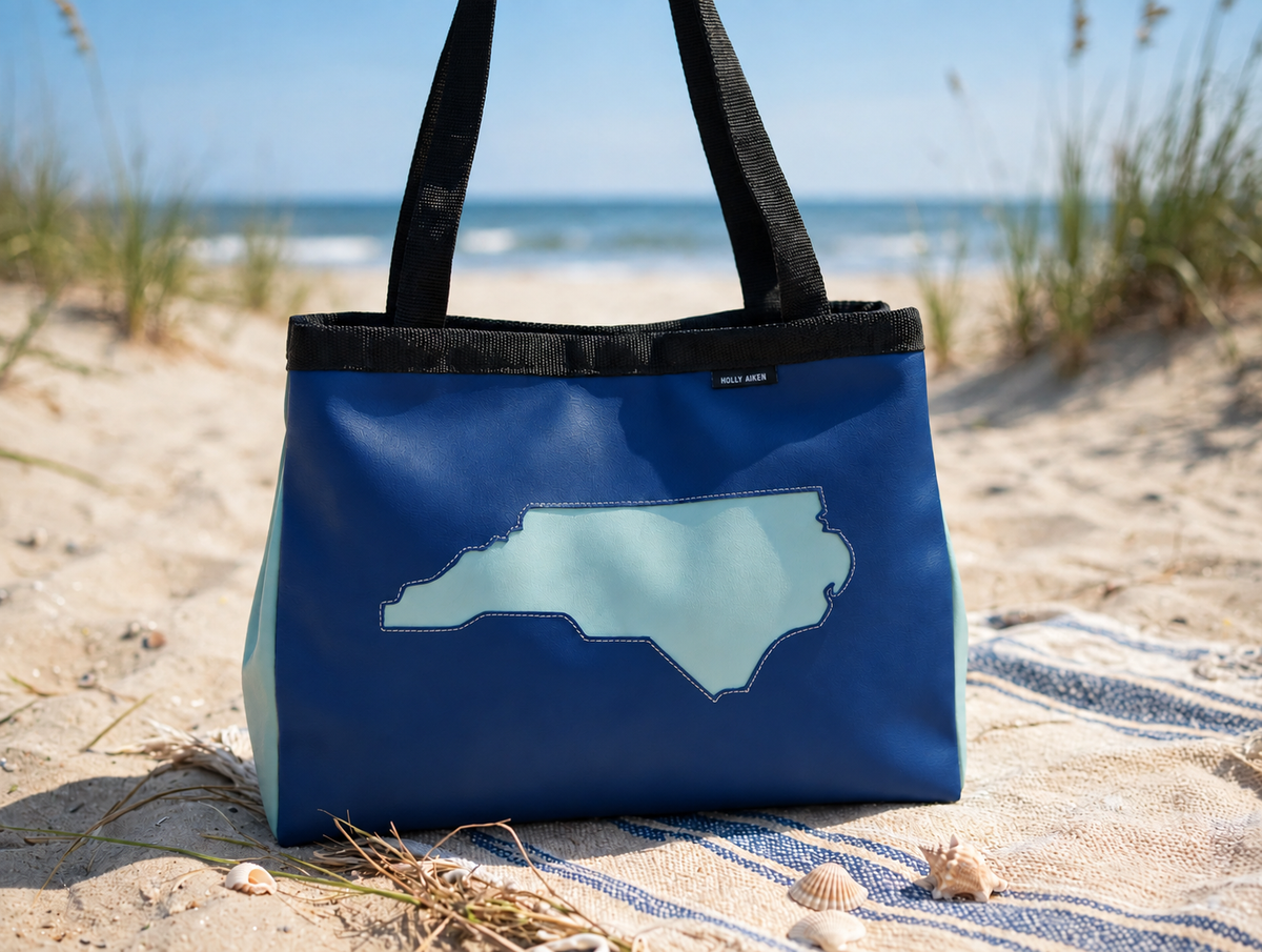 TURBO Aerial tote in Regimental Blue photographed on a beach